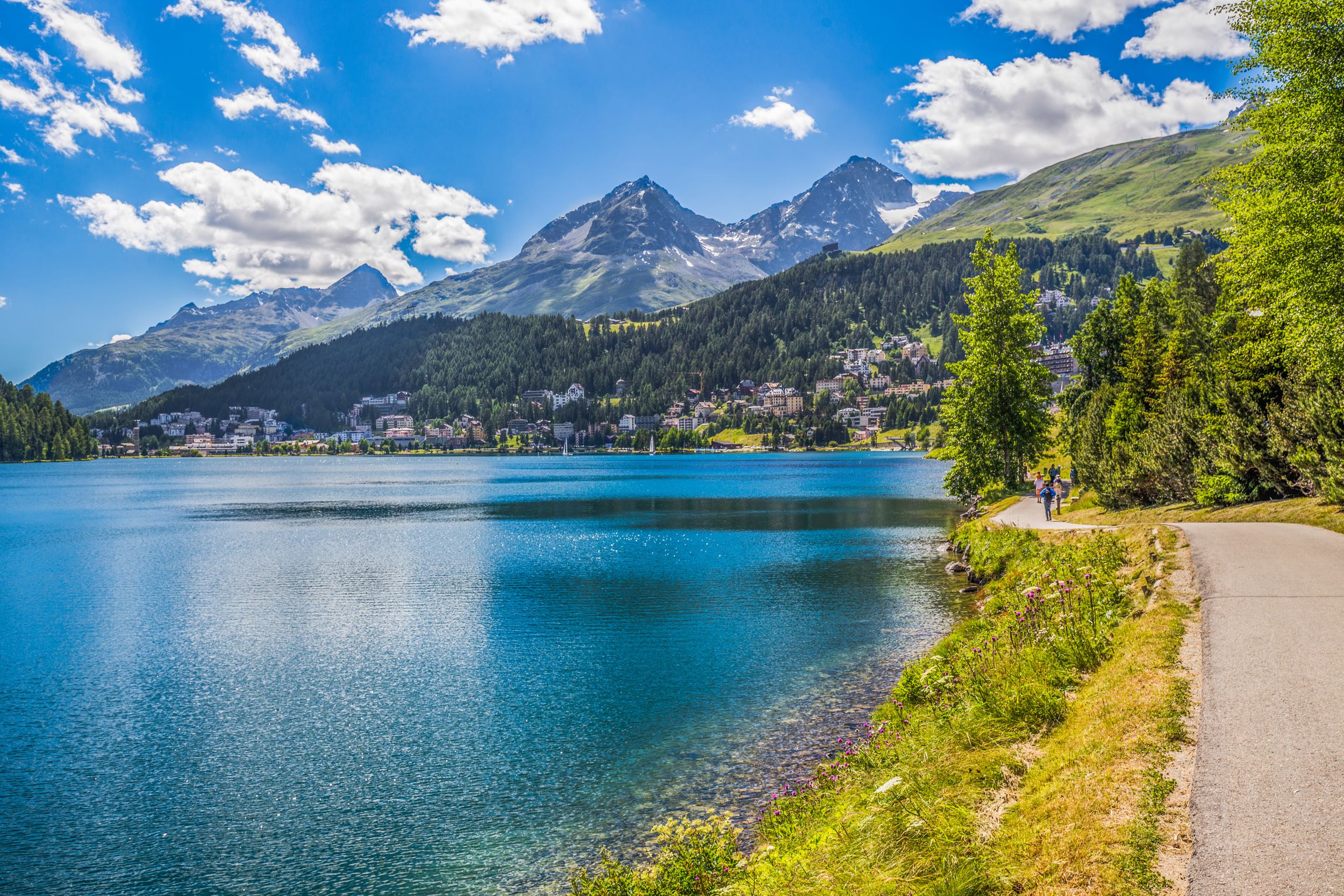 People walking along Lake Sankt Moritz. St. Moritz (German - Sankt Mor