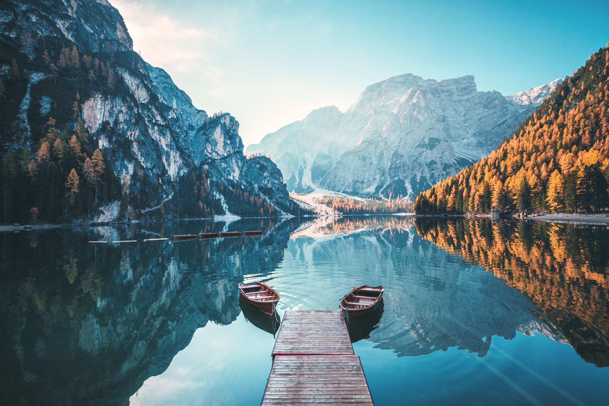 Boats on the Braies Lake ( Pragser Wildsee ) in Dolomites mountains, S