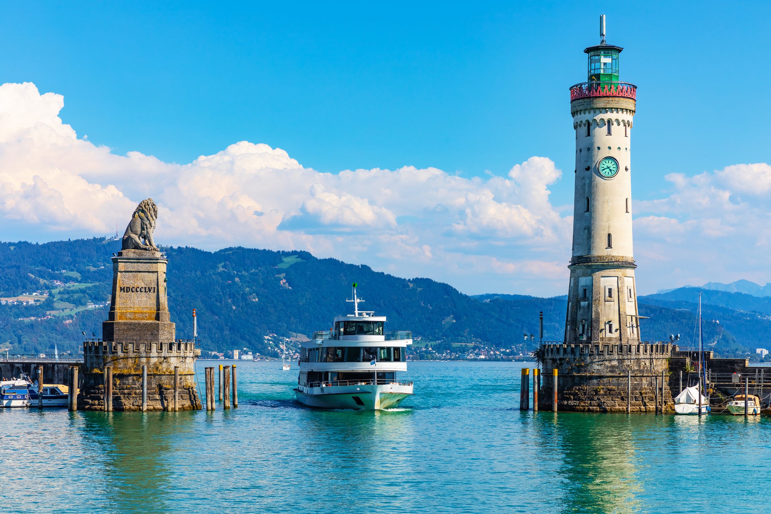 Scenic summer view of the lighthouse and lion statue in the harbor of 