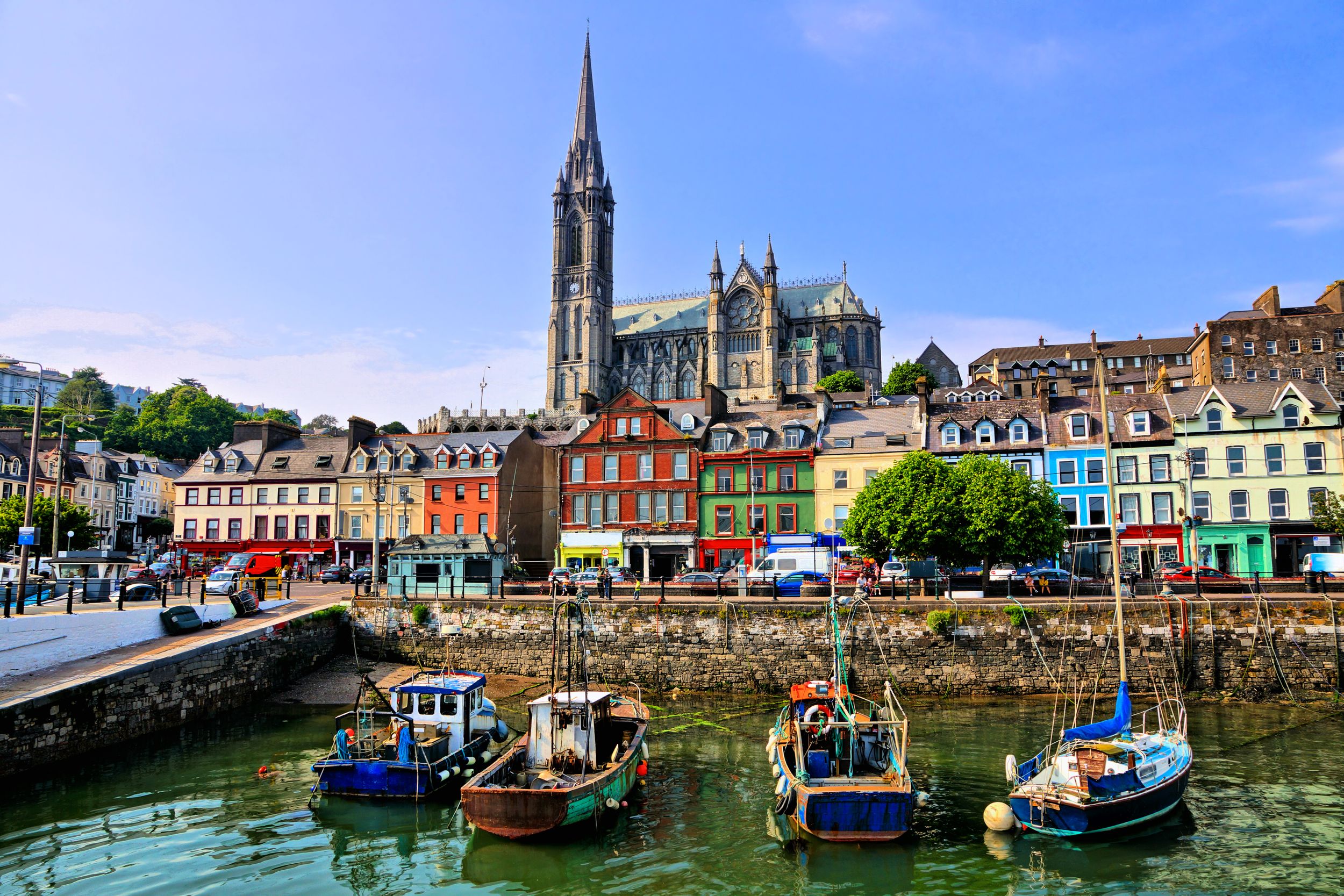 Colorful buildings and old boats with cathedral in background in the h