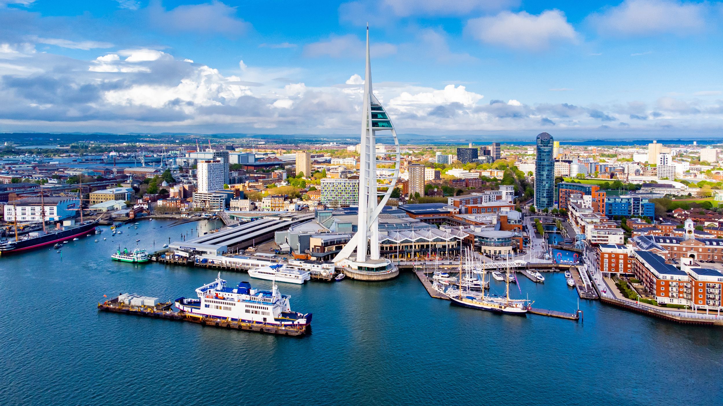 Aerial view of the sail-shaped Spinnaker Tower in Portsmouth Harbor in