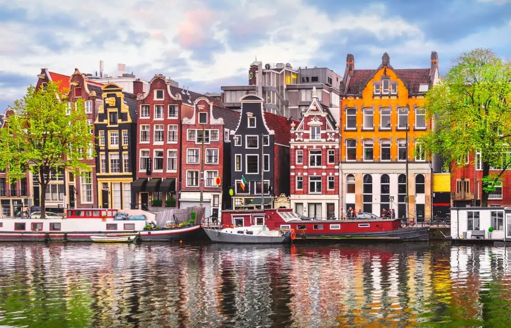 Amsterdam Netherlands dancing houses over river Amstel landmark in old